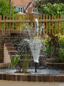 Water feature also contains small fountain in the circular basin.