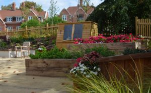 A small garden shed provides a useful storage space.